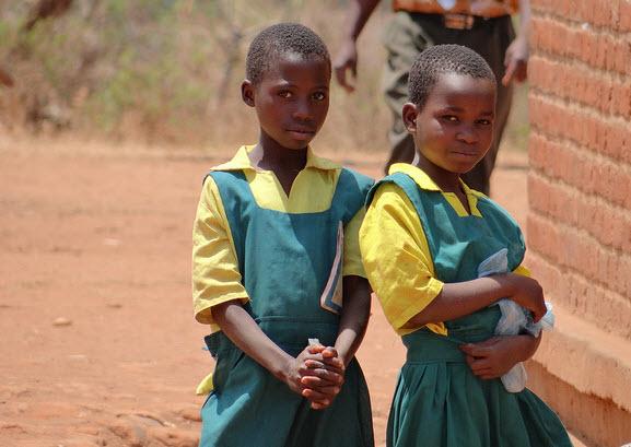 Two girls in their uniforms outside their primary school in Malawi