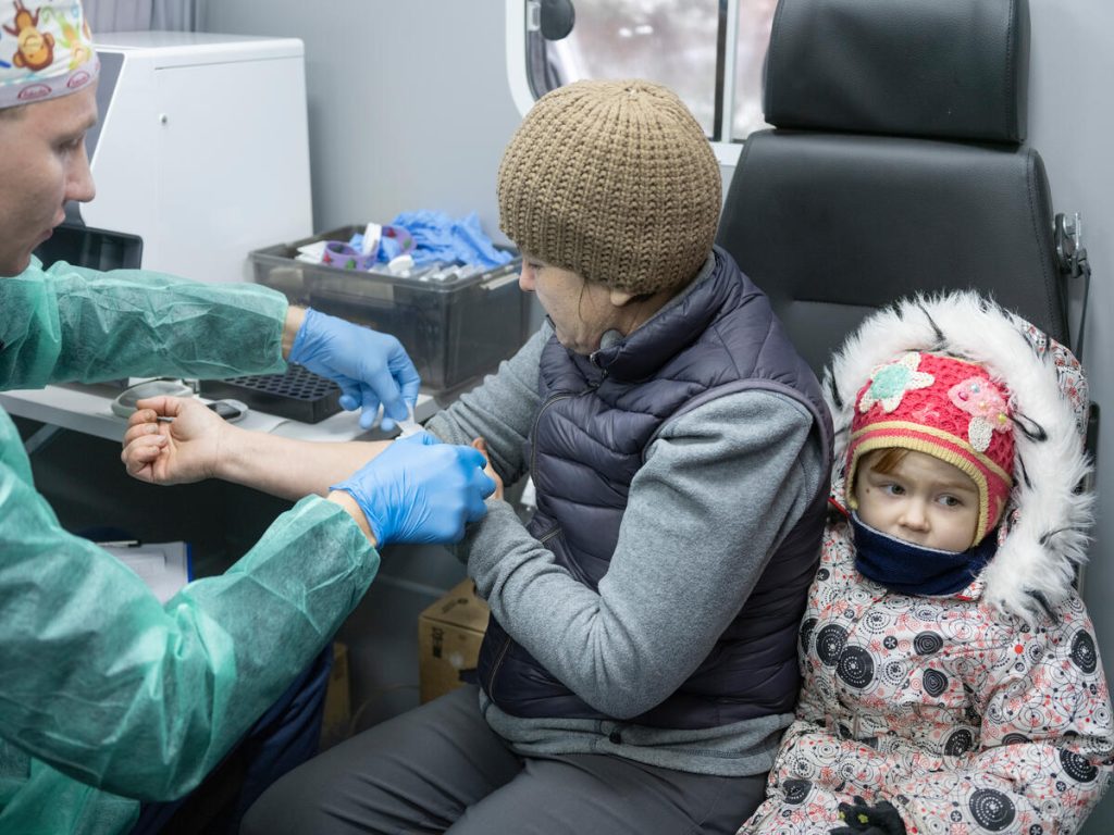 The healthcare worker provides medical assistance to the patient who showed up at the mobile clinic in Svyatohirsk, the war-hit town in Donetsk region, Ukraine, on Dec. 13, 2024.